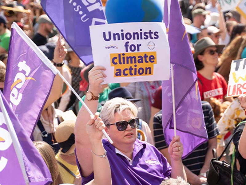 Members at a rally campaigning for action on climate change